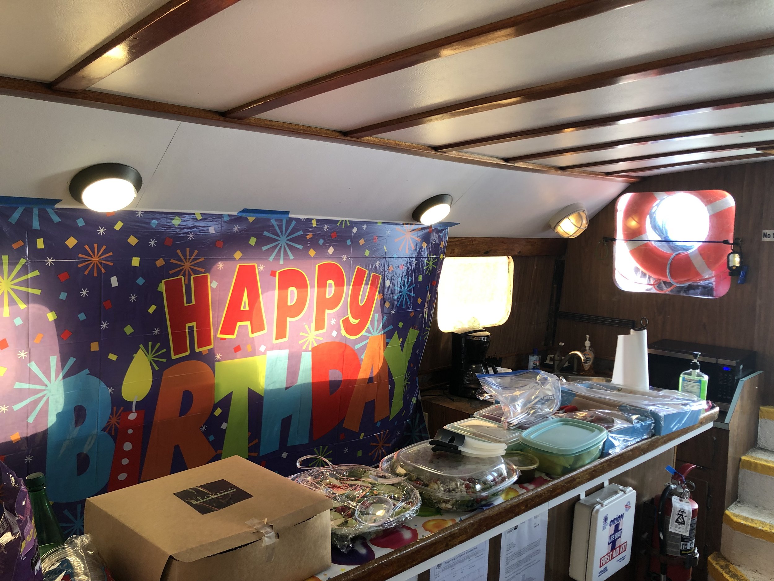 Birthday decorations and food set up inside Sea Trek for a private charter