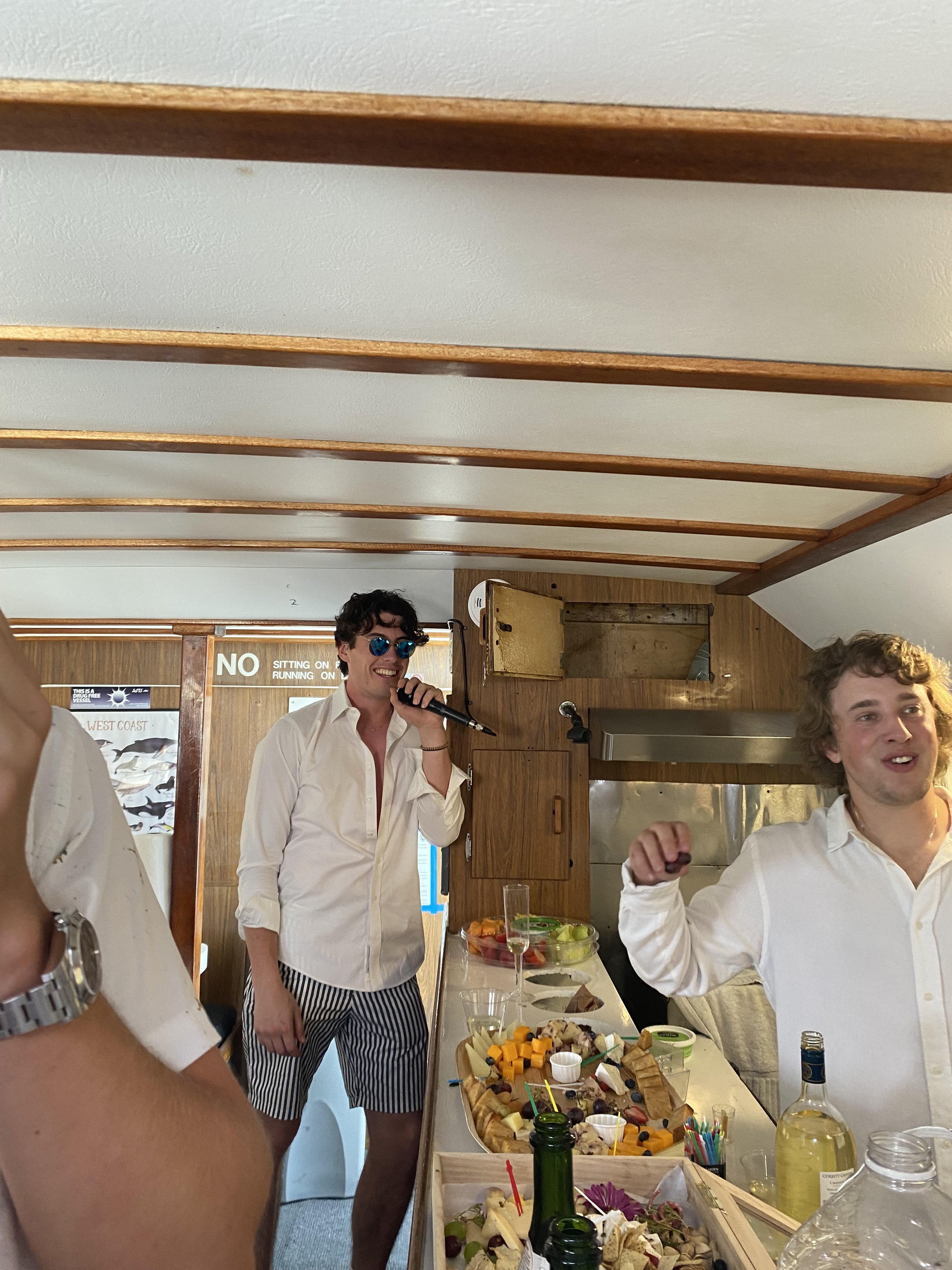 Guest using a microphone inside Sea Trek during a private party charter