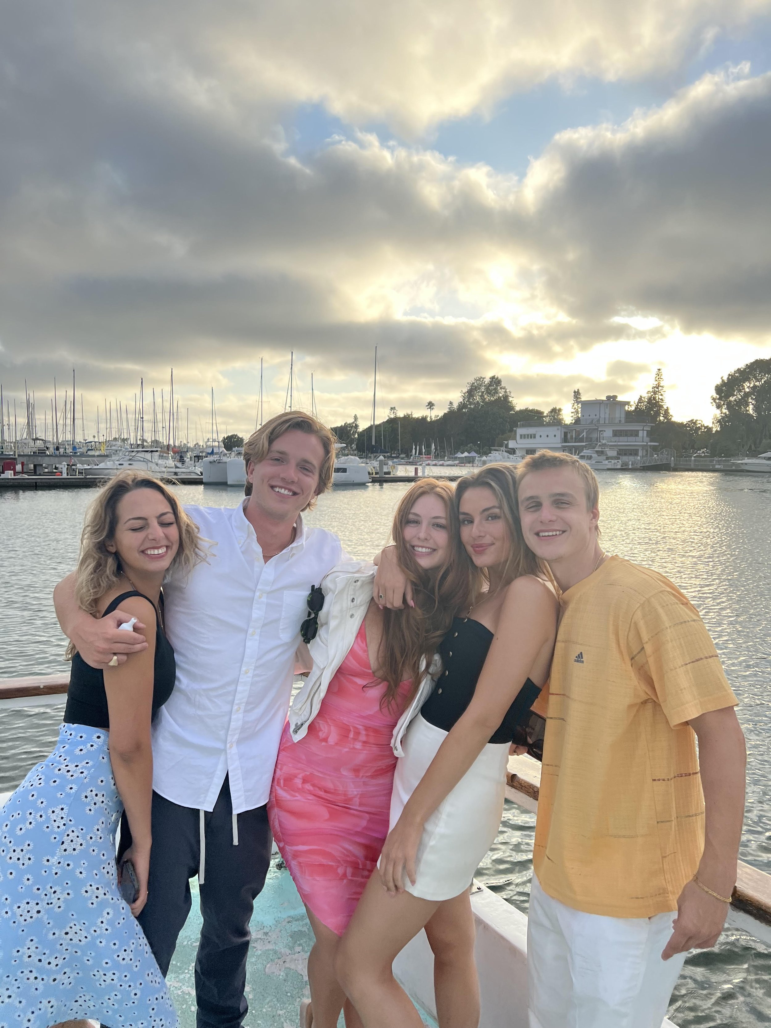 Friends posing on Sea Trek with Marina del Rey harbor at sunset