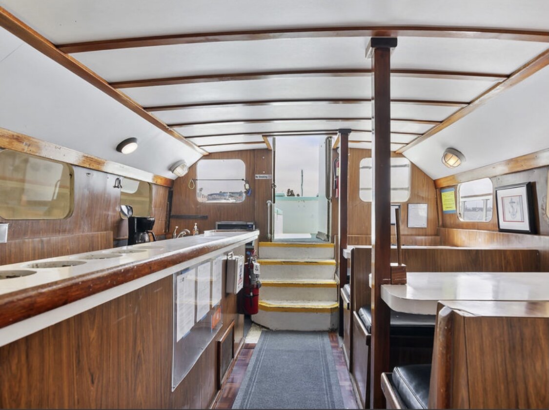 Wood-paneled interior cabin and galley aboard Sea Trek