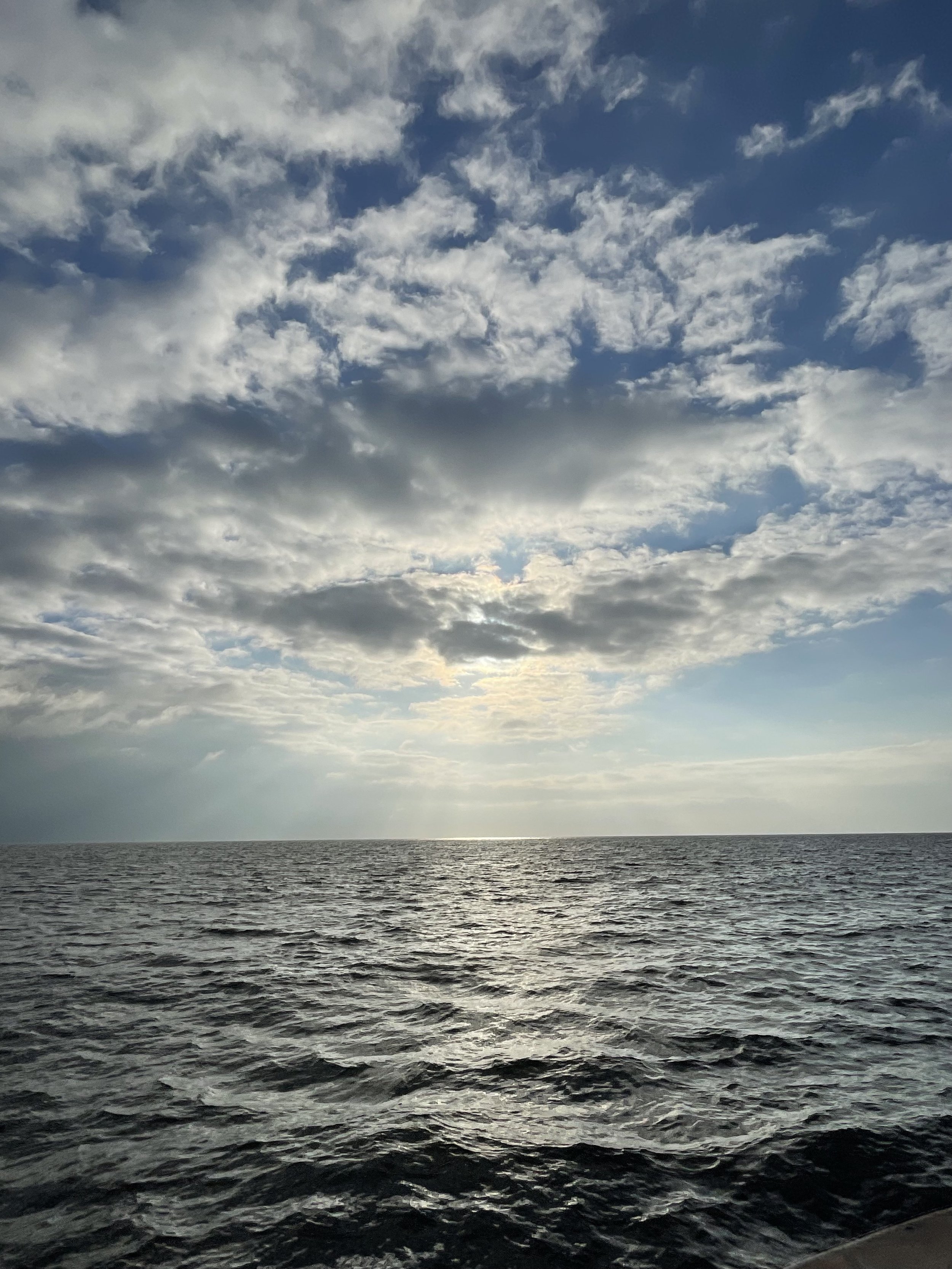 Open ocean and dramatic clouds seen from Sea Trek during a coastal cruise