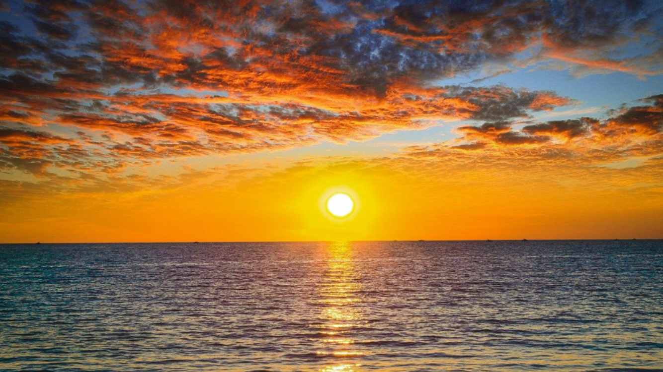 Bright sunset over the Pacific Ocean viewed from a coastal cruise