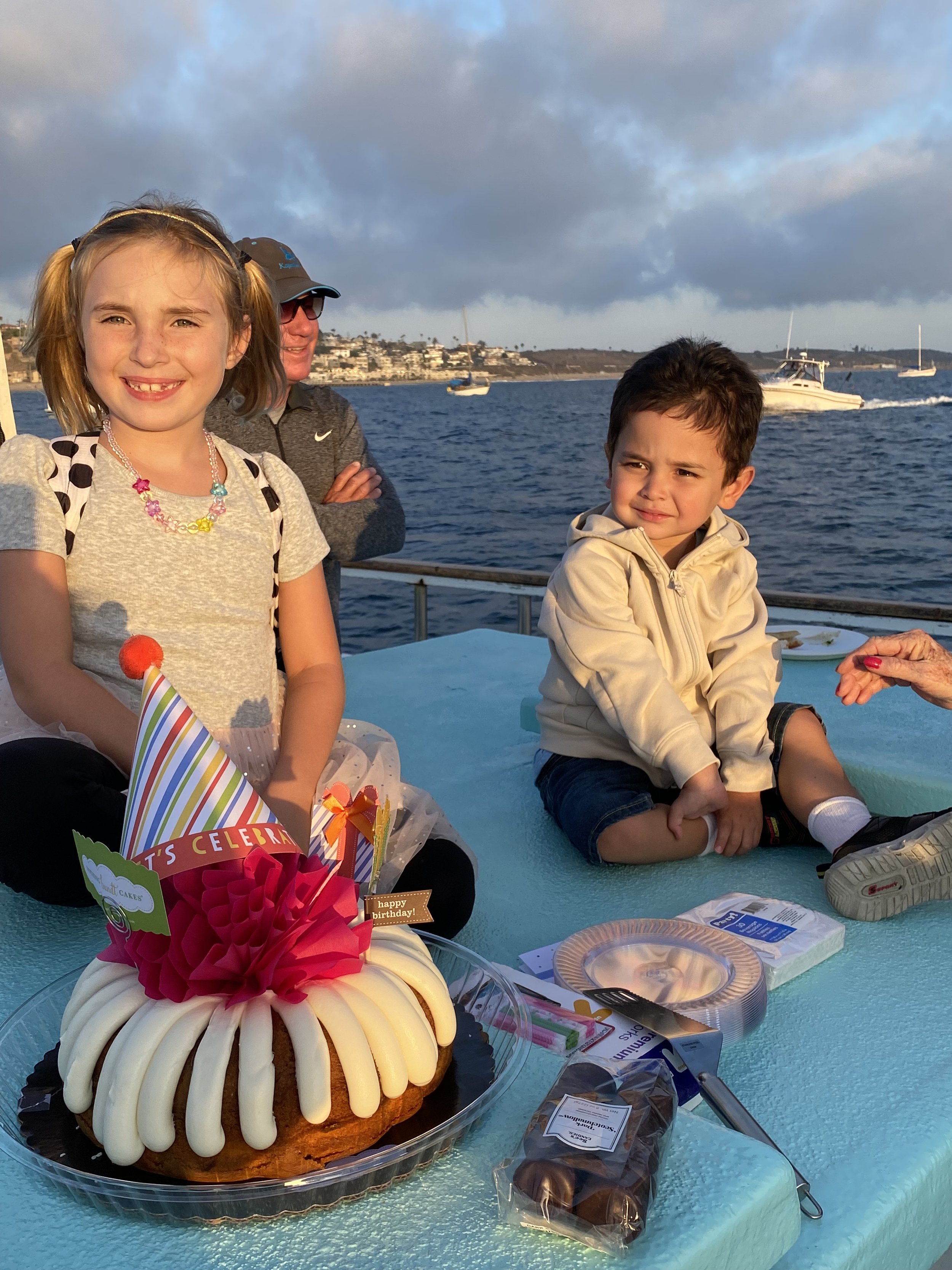 Birthday cake and children aboard Sea Trek during a family celebration charter